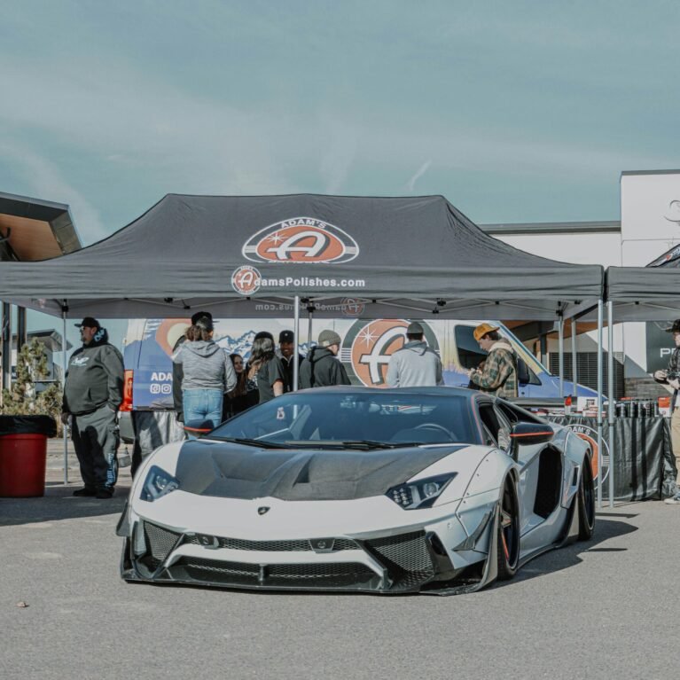 Lamborghini Aventador showcased at a car event in Denver, with a sleek, modern design.