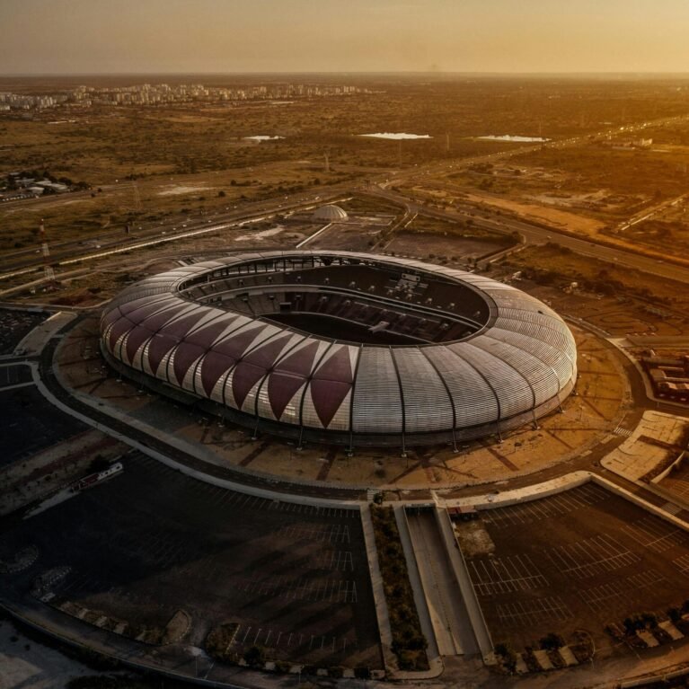 Aerial shot of Estádio 11 de Novembro in Luanda, Angola during sunset, capturing its modern architecture.